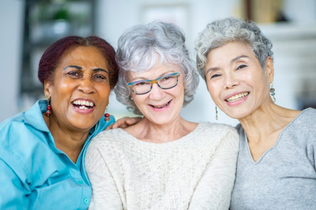 Residents and staff smiling together